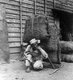 Korea: A coolie re-adjusting his pack, Seoul, early 20th century